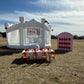 Modern minimalist white bounce house "The Opal" featuring dual inflatable slides and mesh netting for visible play - DFW Confetti Bounce