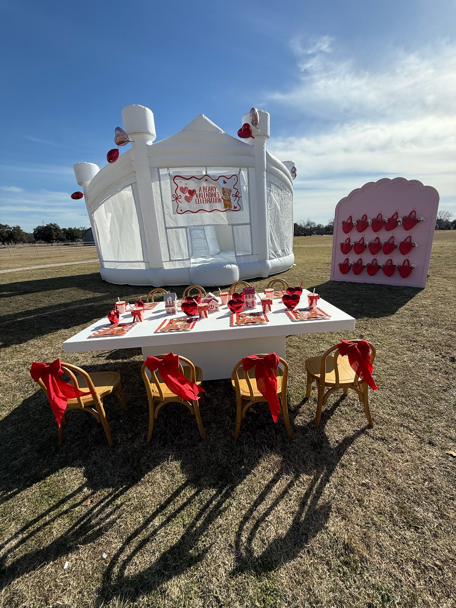 Modern minimalist white bounce house "The Opal" featuring dual inflatable slides and mesh netting for visible play - DFW Confetti Bounce